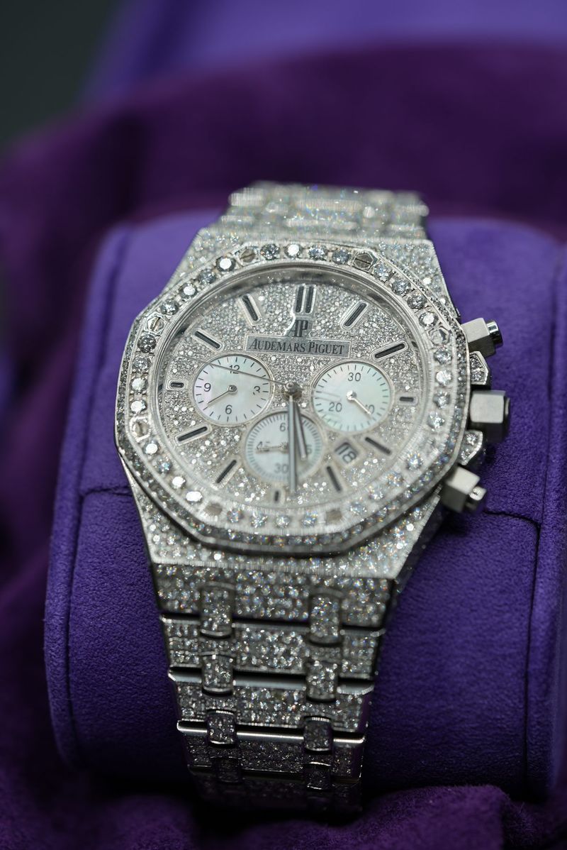 Fully diamond-set Audemars Piguet chronograph on a purple velvet pillow